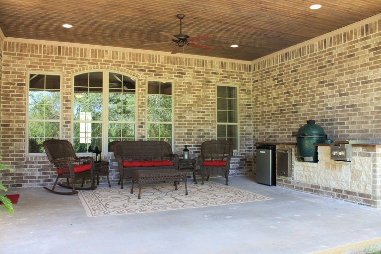 Outdoor kitchen perfect for entertaining, includes green egg, beverage fridge, burners and trash bin. Custom home featured on the Tyler Parade of Homes. www.mckinneyhomesllc.com