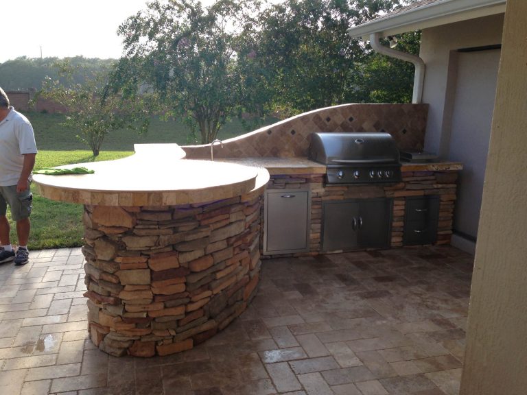 Outdoor kitchen, travertine, cultured stone, rustic southern ledge stone, backsplash, sink, undercounter fridge, curved island, raised bar top, travertine pavers, grill, side burner