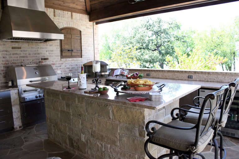 Outdoor kitchen with a great view of the backyard. Designed by Marlene Small, Allied ASID
