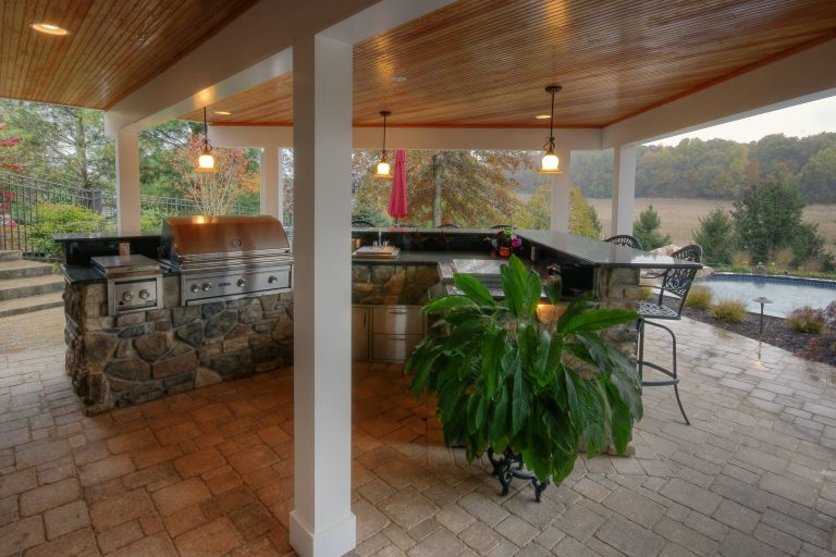 Outdoor kitchen with solid granite counter and bar top