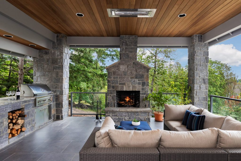 Outdoor living at it's finest. Natural stone veneer with this real wood burning fireplace and bbq enclosure on the covered patio.