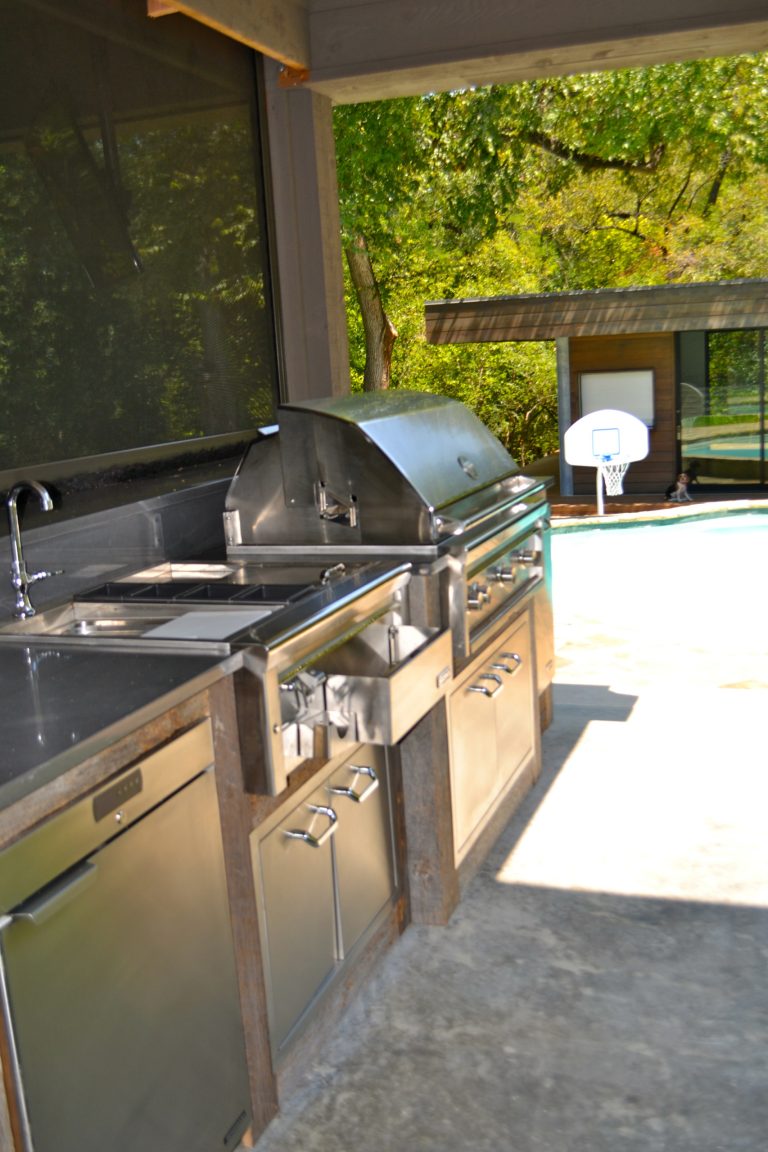 Outside grill area with reclaimed wood to accent stainless appliances.