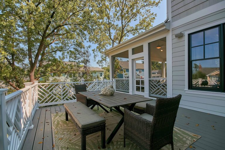 Outside portion of back porch with stairs to the backyard.