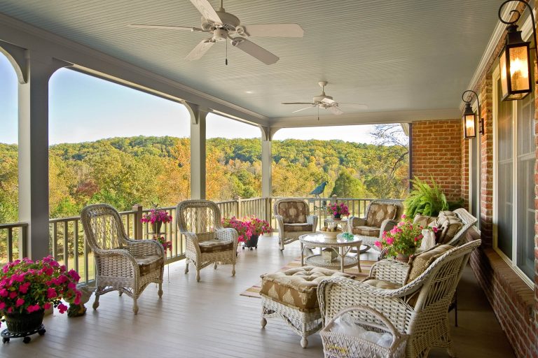 Over looking a river, the old fashioned covered porch of the "Huntington" was sited to take advantage of lazy afternoon breezes and warm natural light. Photo by John Kerber by Dominion Custom Homes | Outdoor Photos | Porch | Landscaping | Landscape Design | Outdoor Living Space | Porch Design Ideas | Outdoor Living Space Ideas | Backyard Design