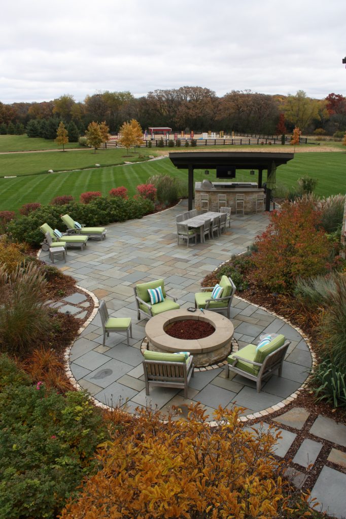 Overview from guest wing of home. The patio area is surrounded with grasses and masses of perennials just starting to take on their autumn color changes.