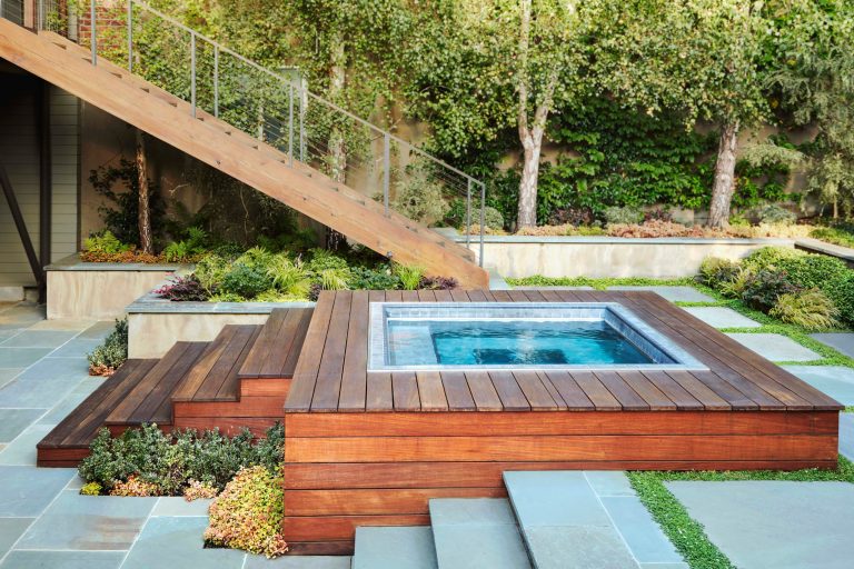 Partially recessed stainless steel spa with tile trim in this compact, San Fransisco backyard. Landscape design by Katharine Webster.