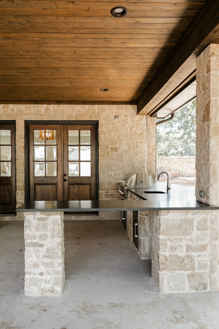 Patio kitchen - backyard patio kitchen idea in Dallas with a roof extension