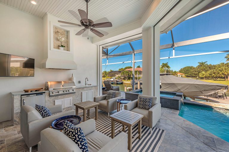 Patio kitchen - coastal tile patio kitchen idea in Other with a roof extension