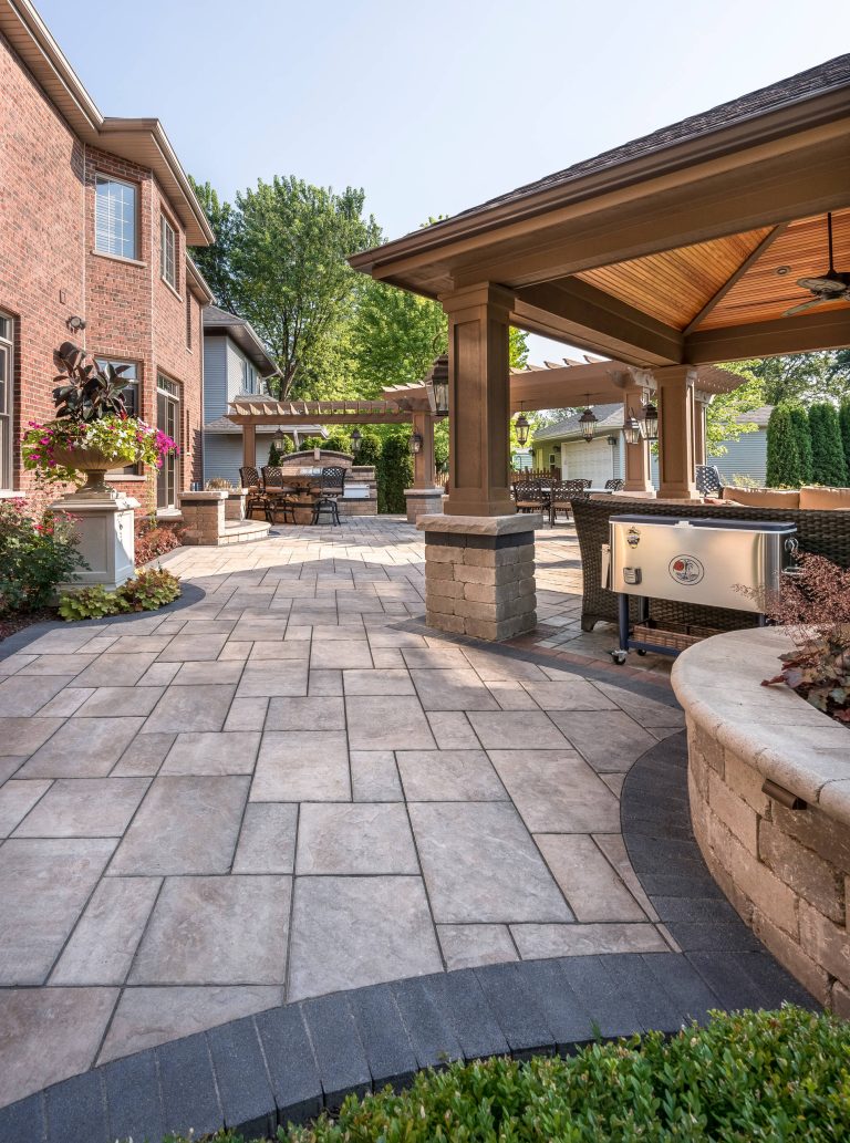 Patio kitchen - contemporary backyard concrete paver patio kitchen idea with a pergola