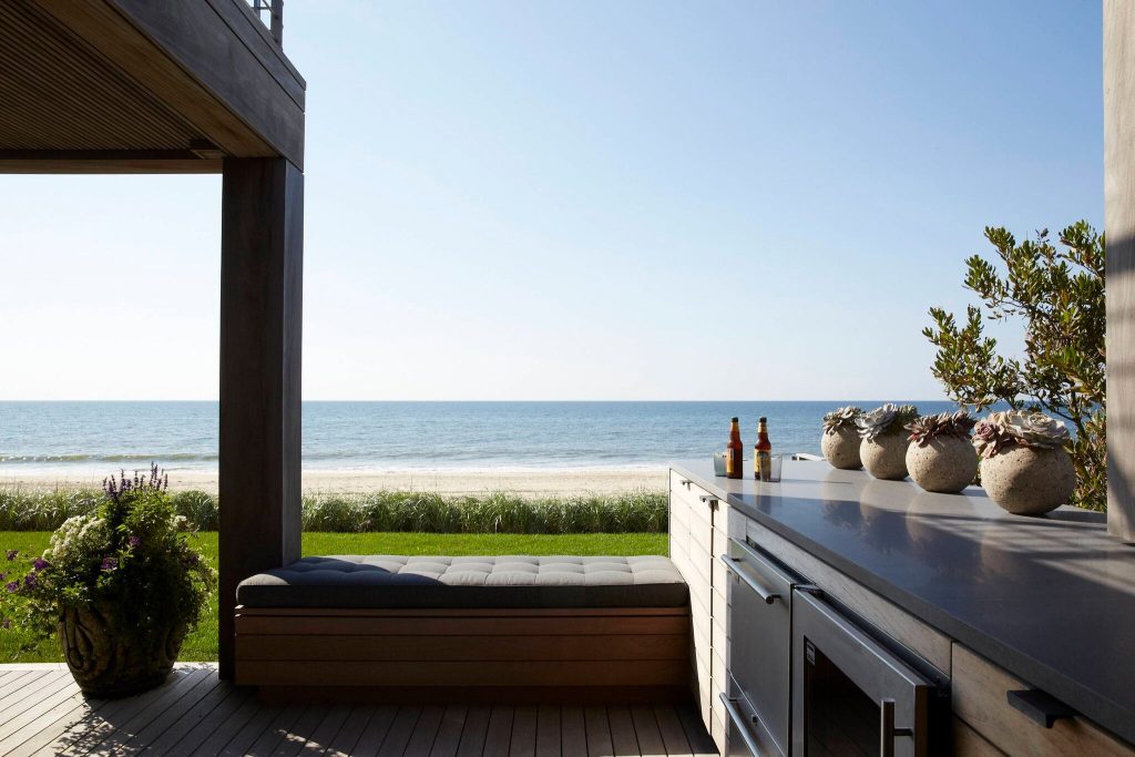 Patio kitchen - contemporary backyard patio kitchen idea in New York