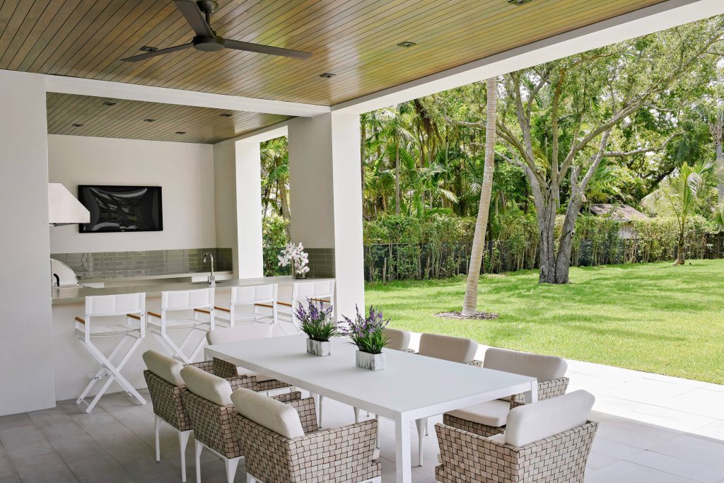 Patio kitchen - contemporary backyard tile patio kitchen idea in Miami with a roof extension