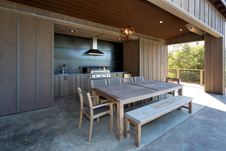 Patio kitchen - contemporary concrete patio kitchen idea in San Francisco with a roof extension