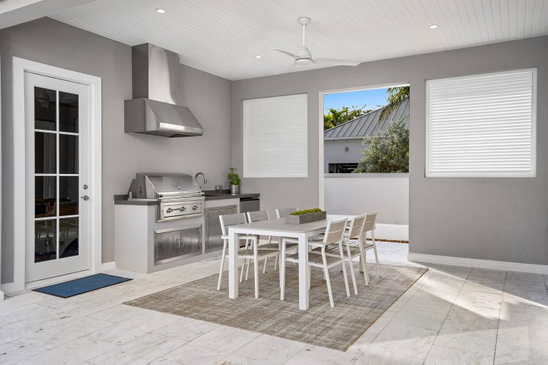 Patio kitchen - contemporary patio kitchen idea in Miami with a roof extension