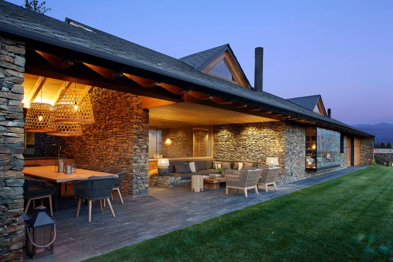 Patio kitchen - country backyard stone patio kitchen idea in Other with a roof extension