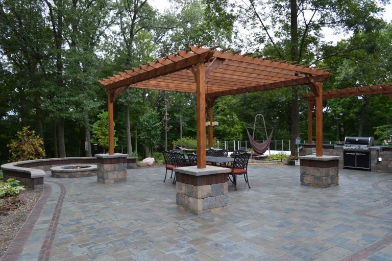 Patio kitchen - huge concrete paver patio kitchen idea in Chicago with a pergola