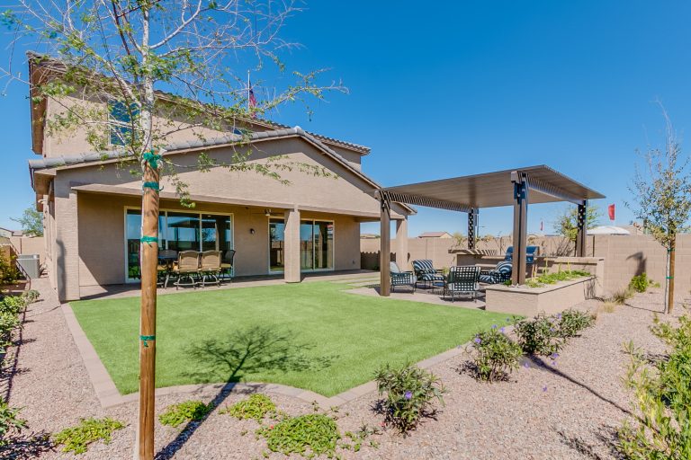 Patio kitchen - huge contemporary backyard brick patio kitchen idea in Phoenix with a roof extension