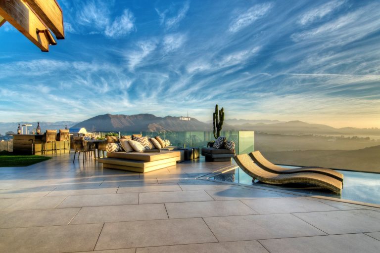 Patio kitchen - huge contemporary backyard concrete patio kitchen idea in Los Angeles with no cover