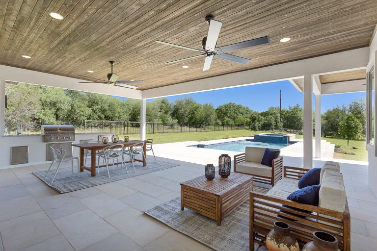 Patio kitchen - huge contemporary backyard stone patio kitchen idea in Austin with a roof extension