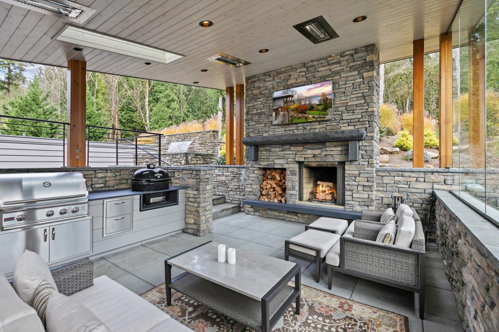 Patio kitchen - huge transitional side yard concrete patio kitchen idea in Seattle with a roof extension