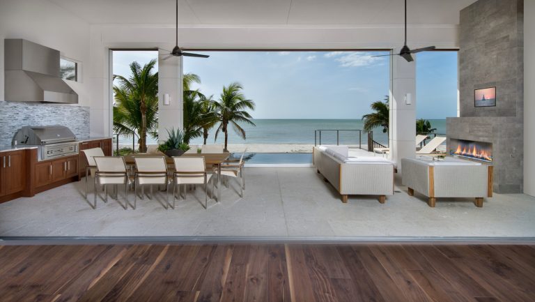Patio kitchen - large contemporary backyard concrete patio kitchen idea in Miami with a roof extension