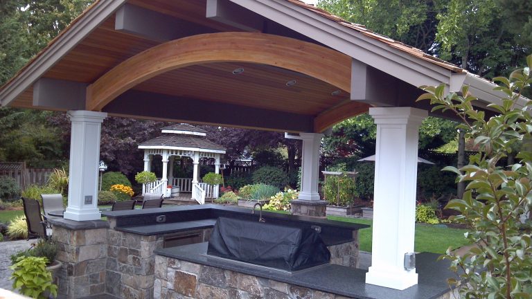 Patio kitchen - large contemporary backyard stamped concrete patio kitchen idea in Portland with a roof extension
