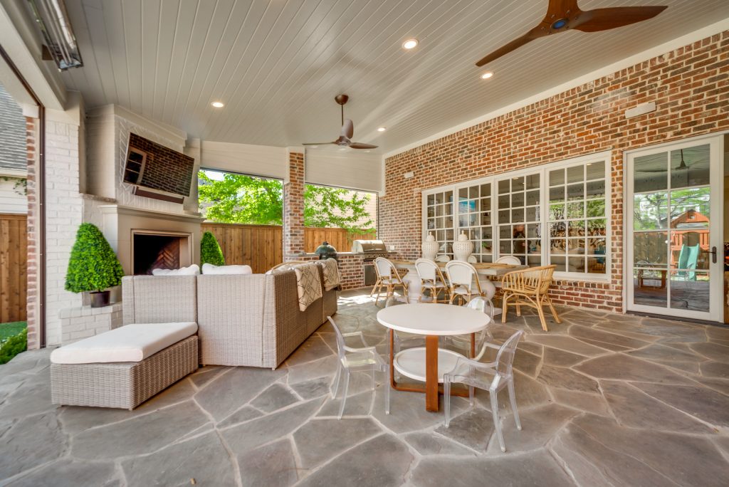 Patio kitchen - large contemporary backyard stone patio kitchen idea in Dallas with a roof extension