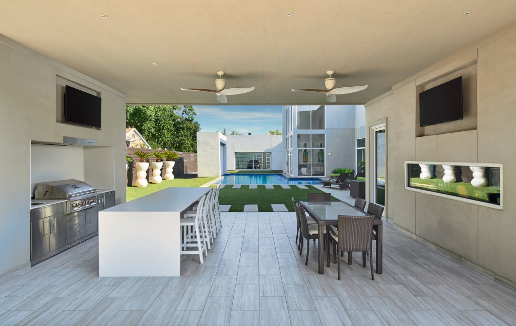 Patio kitchen - large contemporary backyard tile patio kitchen idea in Dallas with a roof extension