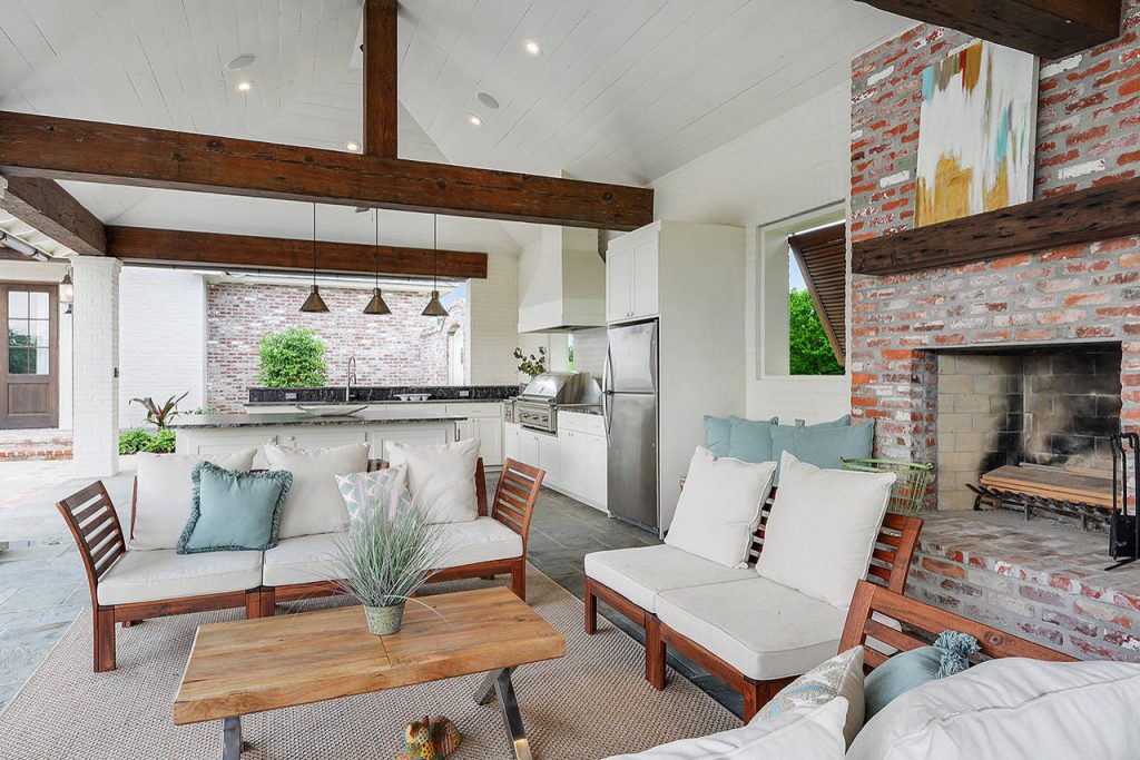 Patio kitchen - large cottage patio kitchen idea in New Orleans with a roof extension