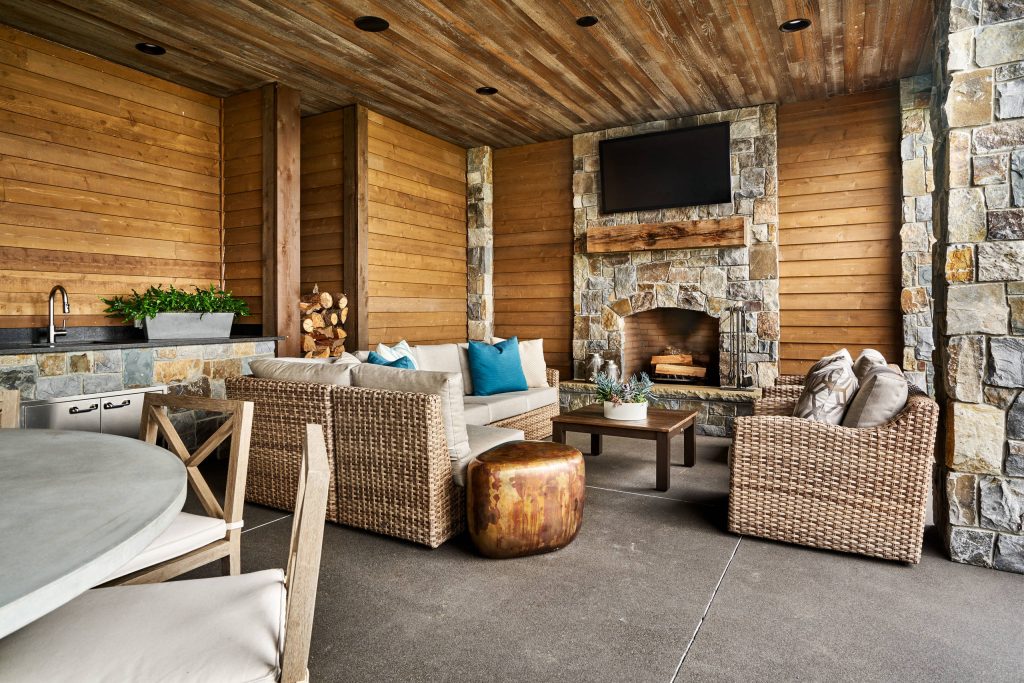 Patio kitchen - large country backyard stamped concrete patio kitchen idea in Portland with a roof extension