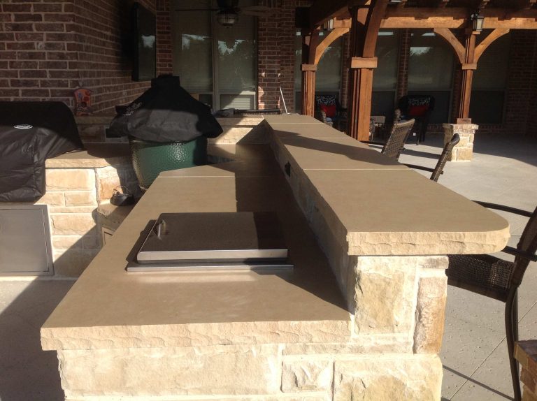 Patio kitchen - large craftsman backyard concrete patio kitchen idea in Dallas with a pergola