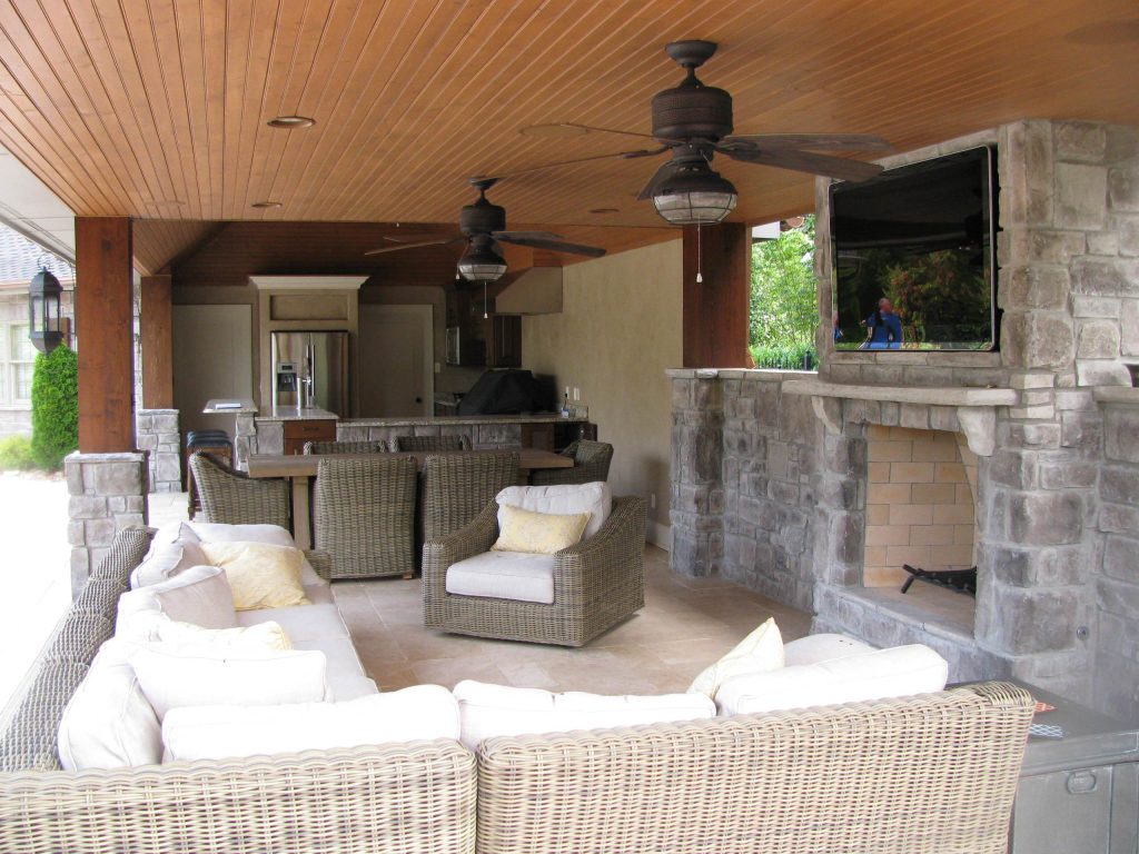 Patio kitchen - large craftsman backyard tile patio kitchen idea in Other with a roof extension