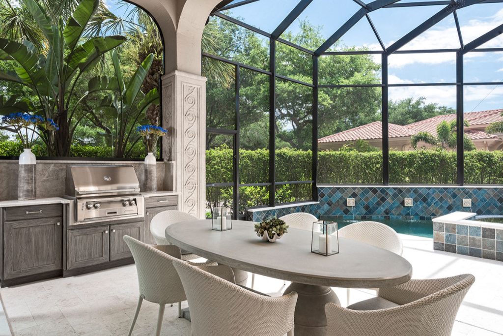 Patio kitchen - large mediterranean backyard patio kitchen idea in Miami