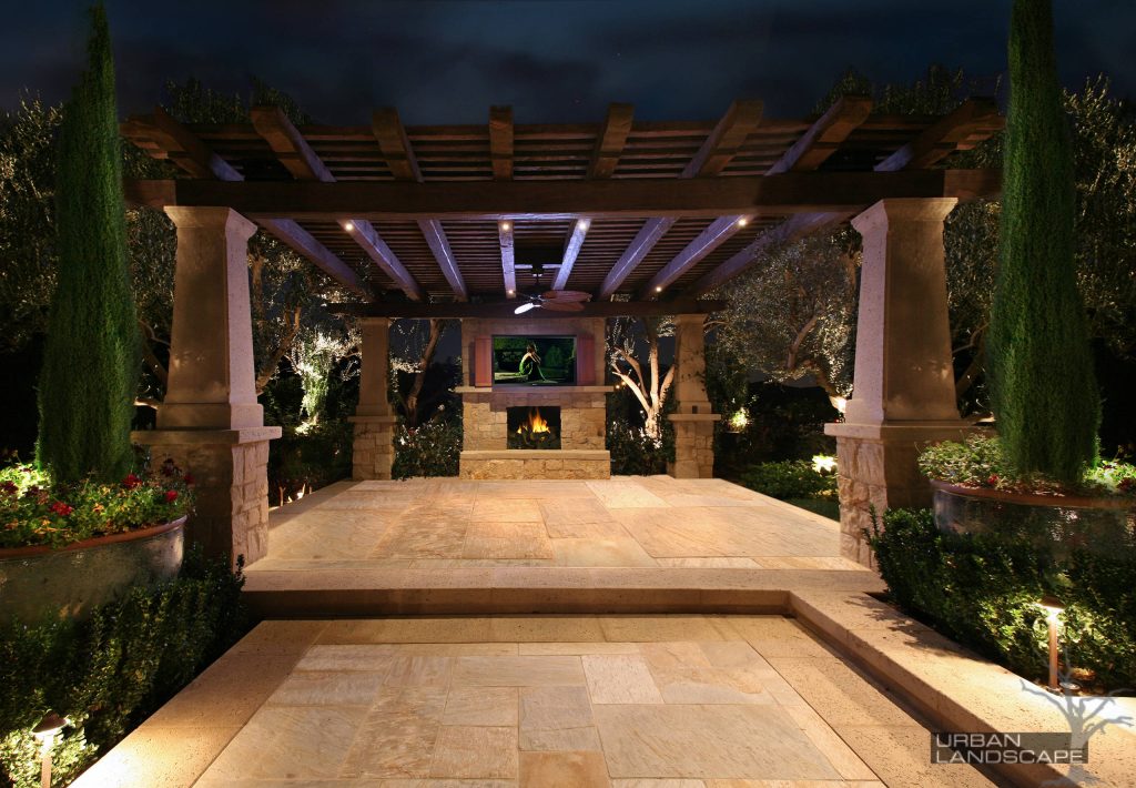 Patio kitchen - large mediterranean backyard stone patio kitchen idea in Orange County with no cover