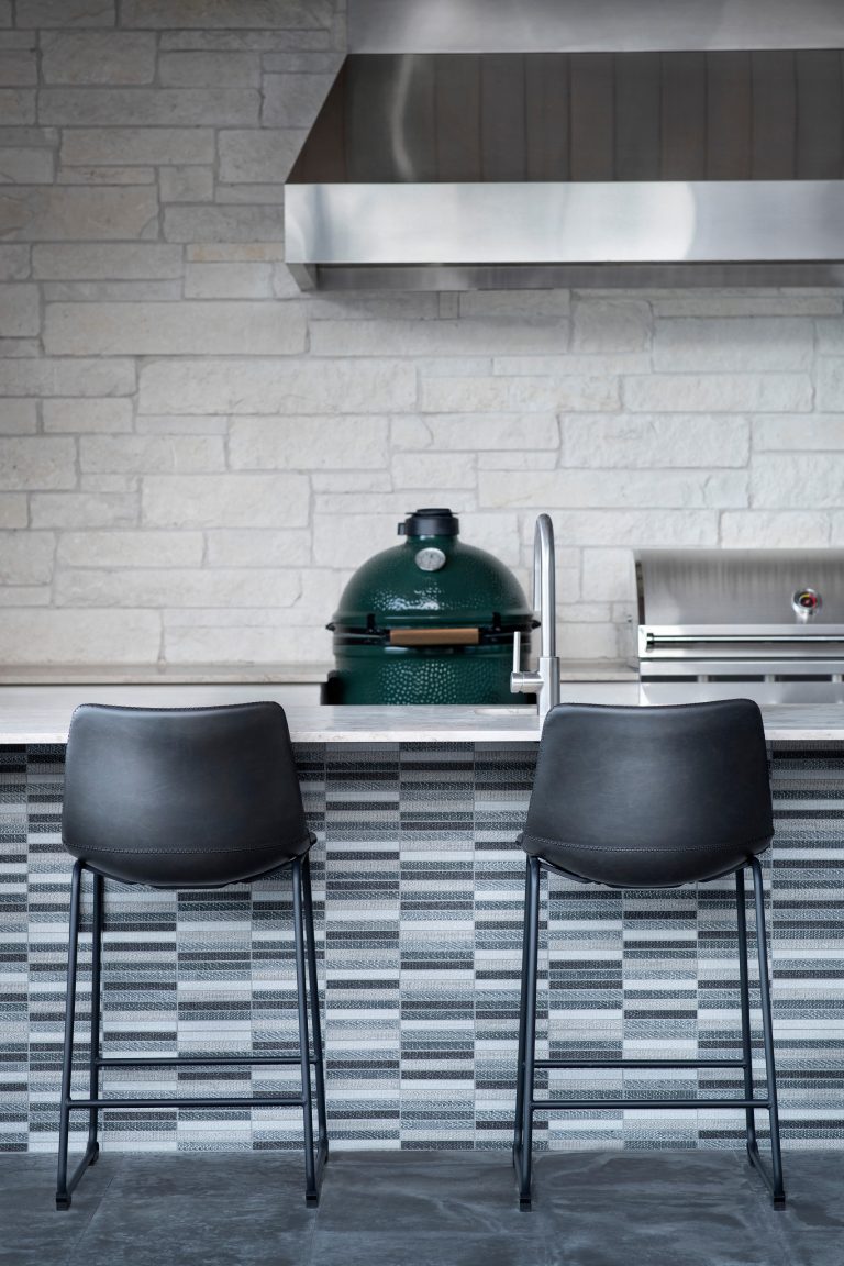 Patio kitchen - large modern backyard concrete patio kitchen idea in Austin with a roof extension
