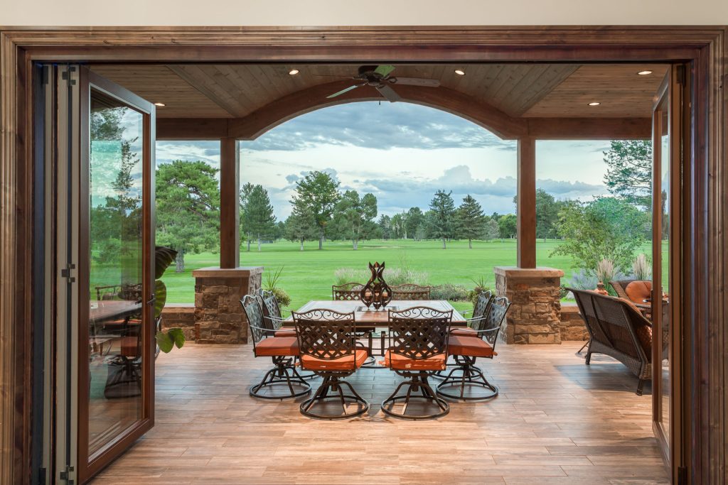 Patio kitchen - large rustic backyard tile patio kitchen idea in Denver with a roof extension