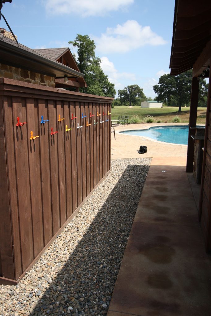 Patio kitchen - large rustic side yard stone patio kitchen idea in New Orleans with a gazebo