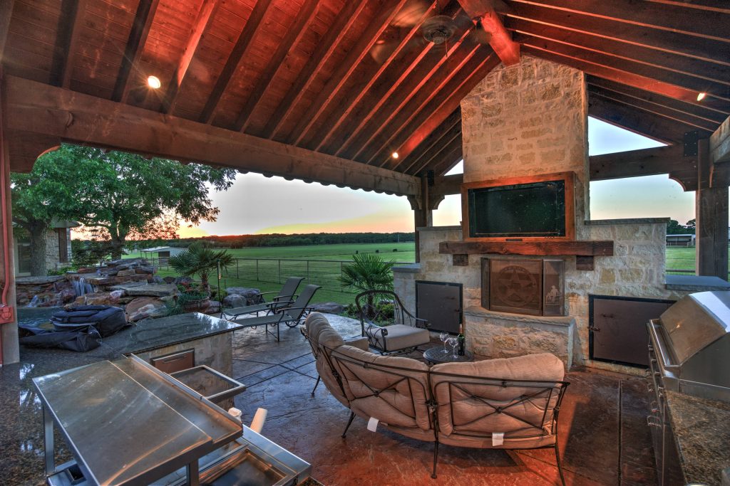 Patio kitchen - large southwestern backyard stamped concrete patio kitchen idea in Austin with a gazebo