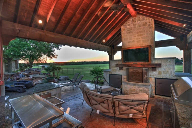 Patio kitchen - large southwestern backyard stamped concrete patio kitchen idea in Austin with a gazebo