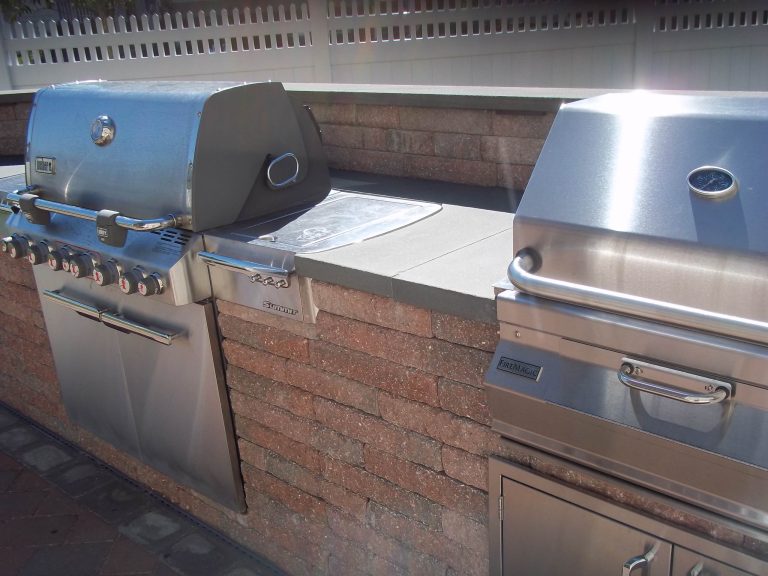 Patio kitchen - large traditional backyard brick patio kitchen idea in New York with no cover
