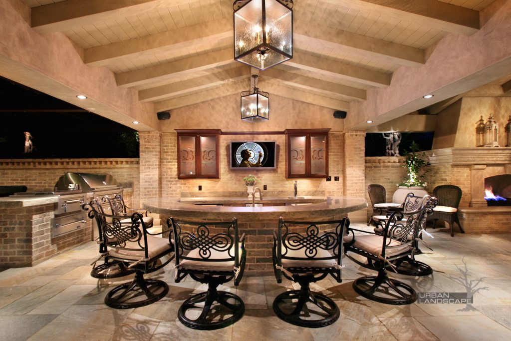 Patio kitchen - large traditional backyard brick patio kitchen idea in Orange County with a pergola