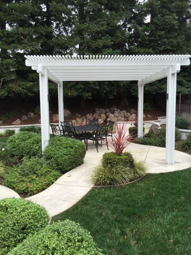 Patio kitchen - large traditional backyard concrete patio kitchen idea in Sacramento with a pergola