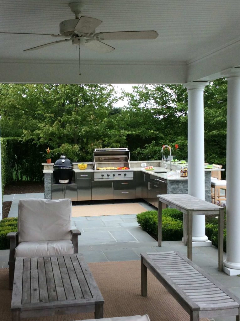 Patio kitchen - large traditional backyard concrete paver patio kitchen idea in New York with an awning