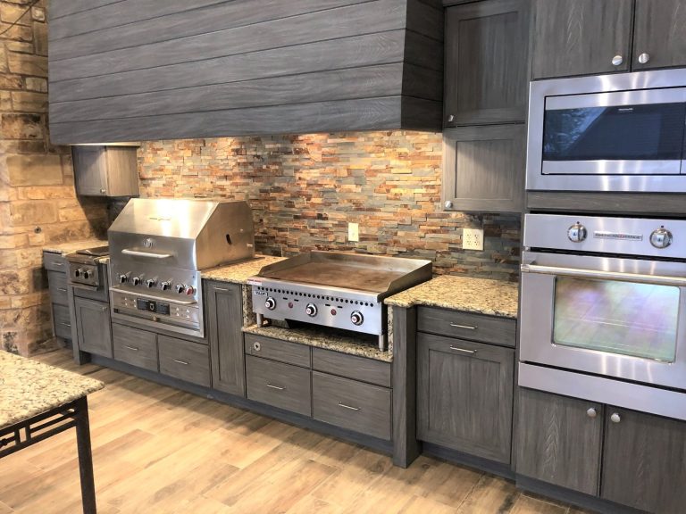 Patio kitchen - large traditional backyard patio kitchen idea in Austin with a gazebo