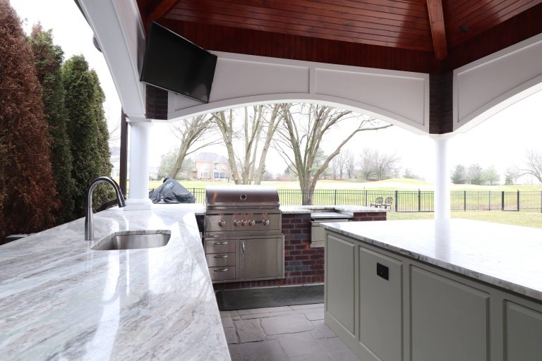 Patio kitchen - large traditional backyard stamped concrete patio kitchen idea in Louisville with a gazebo