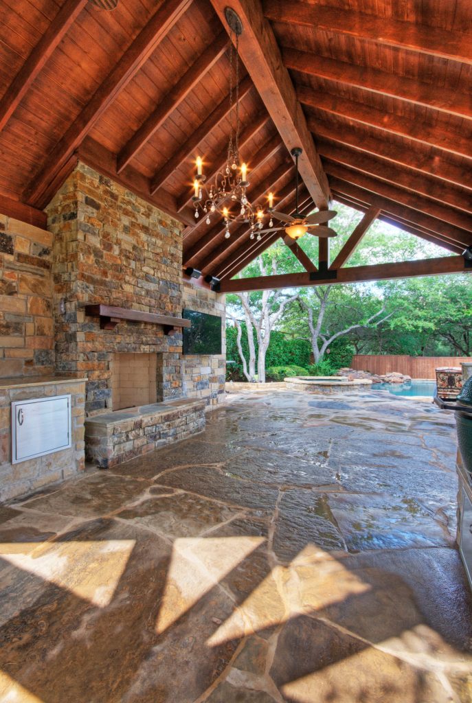 Patio kitchen - large traditional backyard stone patio kitchen idea in Austin with a gazebo