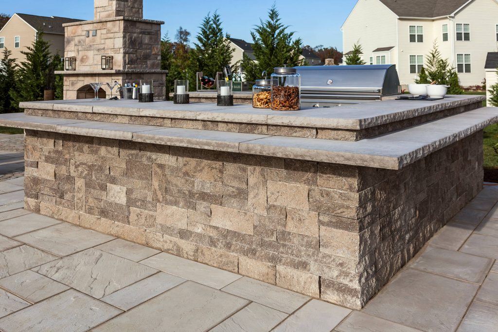 Patio kitchen - large traditional backyard stone patio kitchen idea in Boston with no cover