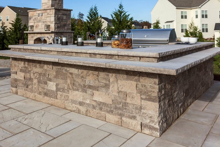 Patio kitchen - large traditional backyard stone patio kitchen idea in Boston with no cover