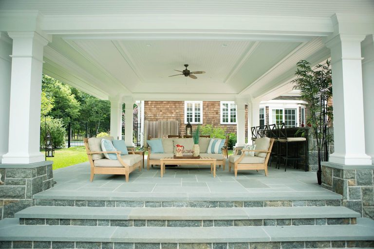 Patio kitchen - large traditional backyard stone patio kitchen idea in New York with a gazebo