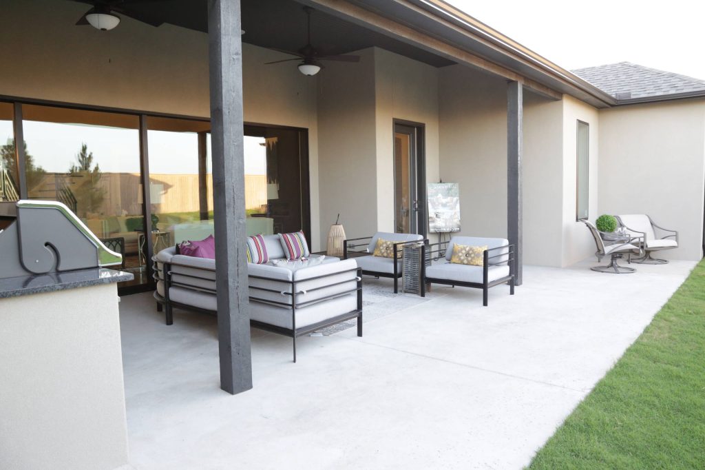 Patio kitchen - large transitional backyard concrete patio kitchen idea in Other with a roof extension
