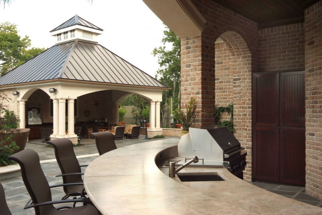 Patio kitchen - large transitional backyard concrete paver patio kitchen idea in Houston with a gazebo
